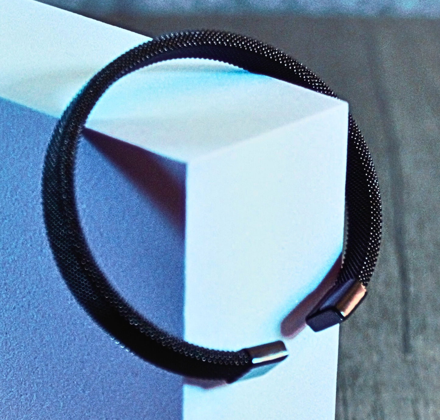 Matte black and iridescent mesh bracelet with metallic tips, styled with futuristic contrast – Obsidian Flux by Charmed Curations.