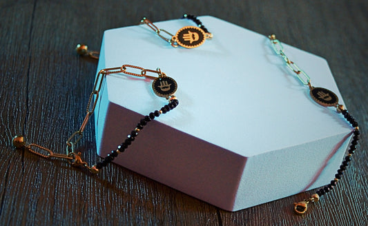 Black faceted bead bracelet with gold Hamsa charm