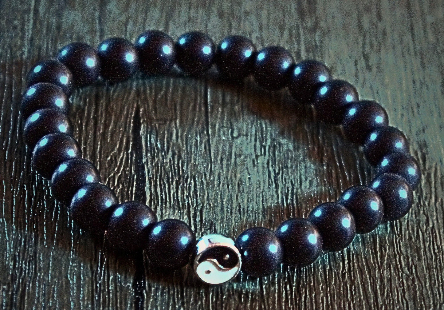 Silver lobster clasp and polished black beads with sleek silver bar detail