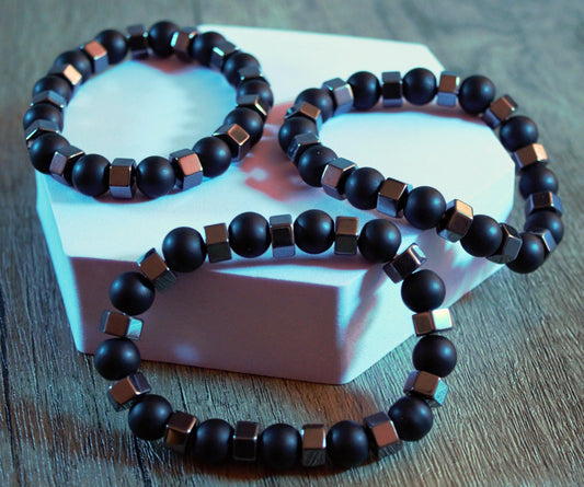 Black cord bracelet with central silver bead
